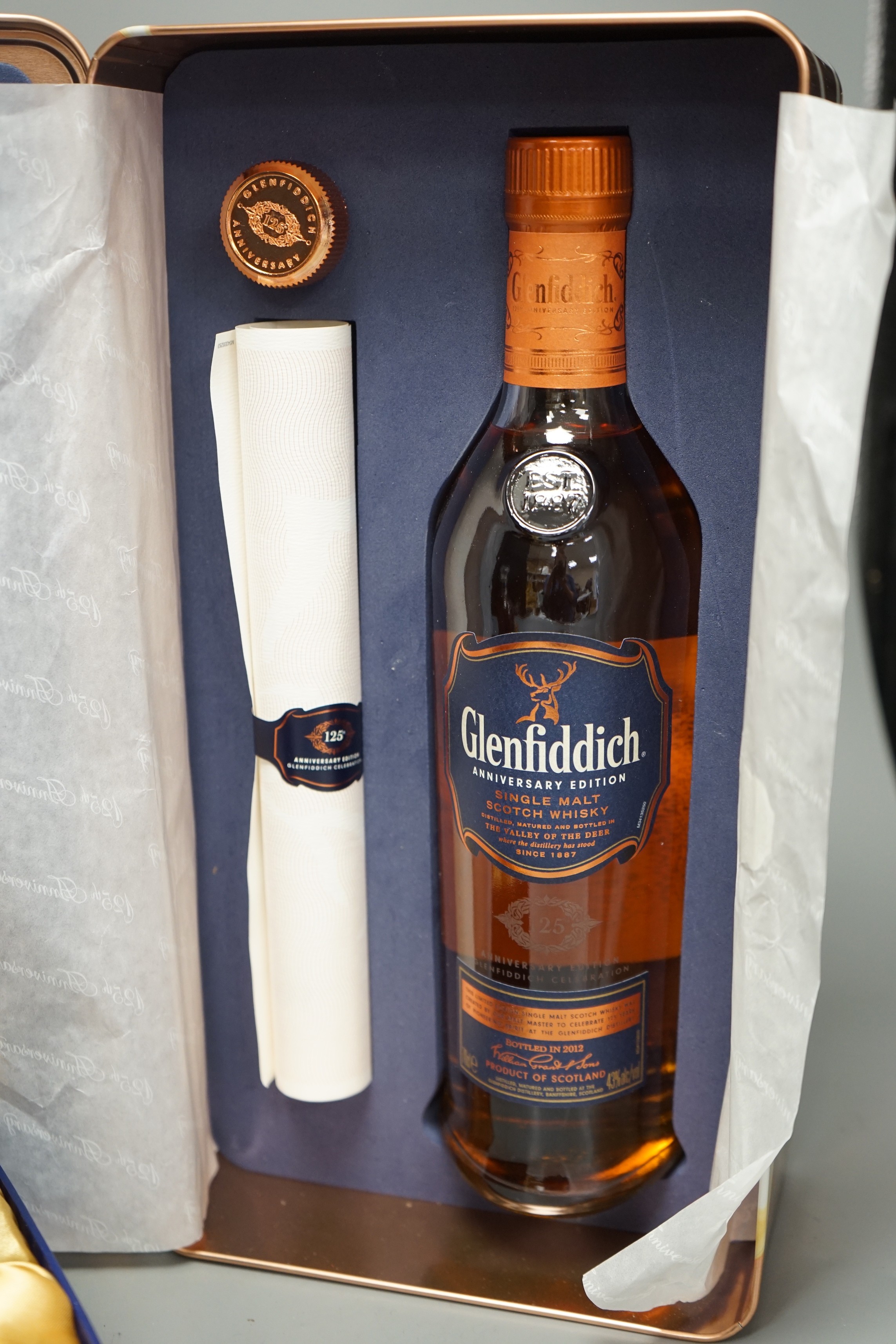 A tin of Anniversary Edition Glenfiddich and a box of Crown Royal Extra Rare Whiskey (2)